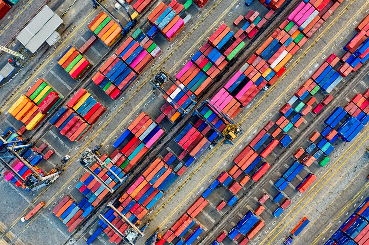 Home Aerial view of vibrant shipping containers at a busy Jakarta port, showcasing global trade.